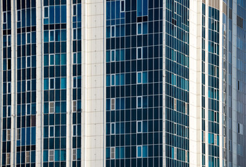 many windows and walls facade of a modern skyscraper without people