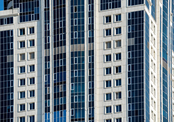 many windows and walls facade of a modern skyscraper without people