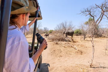 Foto op Aluminium Watching an elephant really close out of a jeep at a safari in Africa © minoandriani