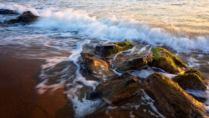 Sunset and sea rocks. Photo taken with the long exposure technique.