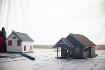 Construction engineers place plans and model homes  on desks in their offices for real estate...