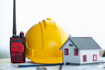 Yellow helmet were prepared for Construction engineers to wear before entering the construction area to prevent  danger of falling objects from working. Yellow safety helmet is placed on white table.