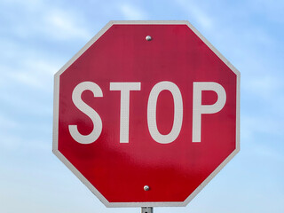stop traffic sign isolated on blue sky