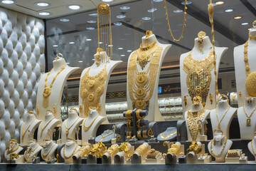 Showcase of a jewellery store with many golden items on display. Deira gold souk market, Dubai, UAE.