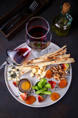 Wine with fruits on a plate is beautiful