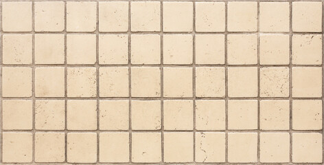 Vintage beige ceramic tile of square shape. The surface is made of ceramic tiles.