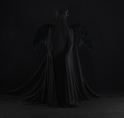 demon angel with black wings on a black background