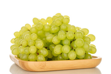 Sweet juicy seedless grapes on bamboo tray, macro, isolated on white background.