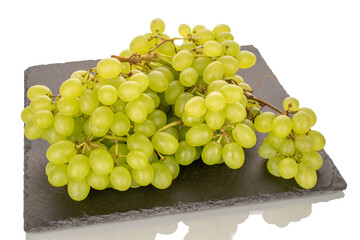 Sweet juicy seedless grapes on a stone tray, macro, isolated on white background.