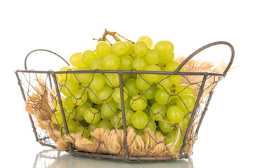 Sweet juicy seedless grapes in basket, macro, isolated on white background.