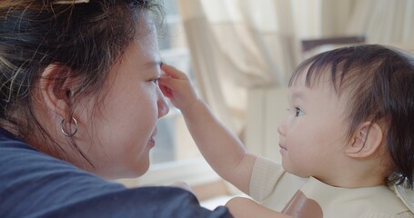 Closeup happy asian family little cute toddler daughter girl playing looking at mother enjoy spending time together with love in living room, Concept of love relationship and motherhood