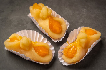 Portuguese marzipan delicacy in shape of basket. Gourmet sweets from Algarve Portugal on a marble background close-up.