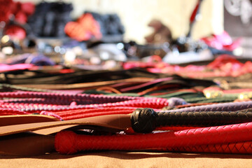leather whips in different colors at the bdsm fair