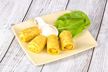 Stuffed pancakes with cream sauce