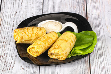 Stuffed pancakes with cream sauce