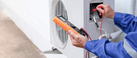 Air conditioner technician checking air conditioner operation