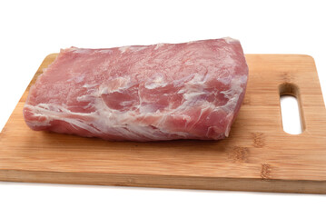 Close-up of carbonade - raw pork meat on a cutting board over a white background.