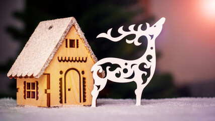 Carved out of wood reindeer and a house for decorating a Christmas tree