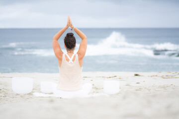 Fototapeta na wymiar Yoga and crystal bowls at the beach