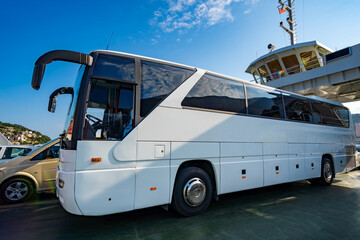 ferry transports bus and cars, passengers, across the bay, close view of autobus and deck © soleg