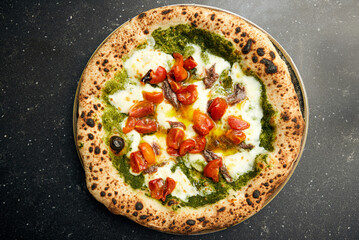 Pizza Perfection: Pesto, Mozzarella, and Tomato Delight on Black Marble
