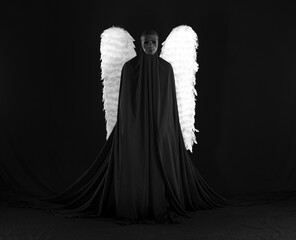 demon angel with white wings on a black background