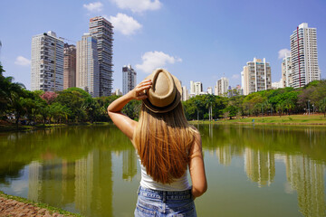 Visiting Goiania, Brazil. Back view of young woman in Parque Sulivan Silvestre also known as Parque Vaca Brava, a city park in Goiania, Goias, Brazil.