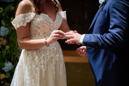 Anonymous bride and groom exchanging rings during wedding