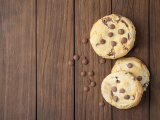 Chocolate chip cookies over wooden table with copy space