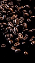 Obraz premium Flying roasted coffee grains on a black space