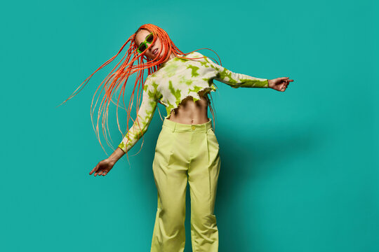 Stylish woman in green outfit and sunglasses