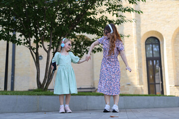 Two happy and cute young girls enjoying a beautiful day in the park during the summer, representing the joys of childhood and family.