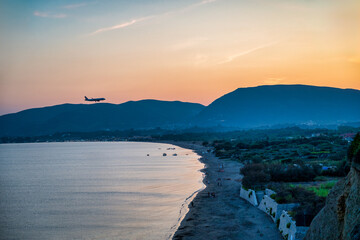 A plane flies over Laganas Bay on the island of Zakhyntos 