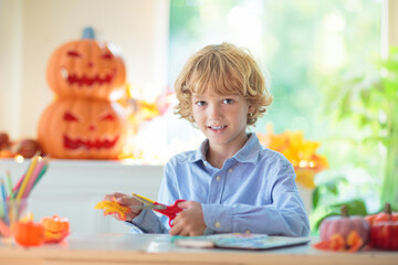 Family decorating home. Halloween arts and crafts.