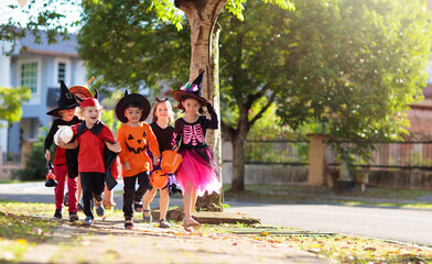 Kids trick or treat. Halloween fun for children.