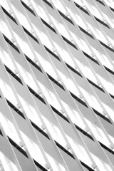 Capture the essence of contemporary design with this striking image featuring a white, metallic building adorned with abstract geometric shapes, showcasing modern architectural brilliance.