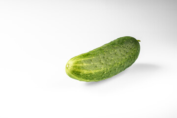 Fresh green cucumber with pimples on a white background