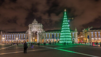 Fototapeta na wymiar Commerce square illuminated and decorated at Christmas time in Lisbon night timelapse hyperlapse