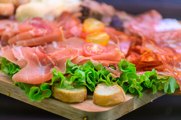 Fresh cuts of French cured sausages, ham, cheeses for party close up