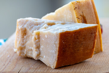 Traditional italian food - 36 months aged in caves Italian parmesan hard cheese from Parmigiano-Reggiano, Italy