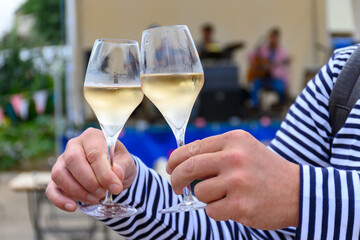 Tasting of sparkling white wine with bubbles champagne on summer festival route of champagne in Cote des Bar, Champagne region, France