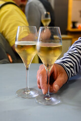Tasting of sparkling white wine with bubbles champagne on summer festival route of champagne in Cote des Bar, Champagne region, France