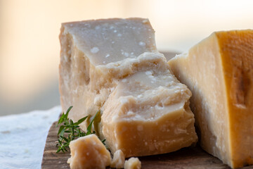 Traditional italian food - 36 months aged in caves Italian parmesan hard cheese from Parmigiano-Reggiano, Italy