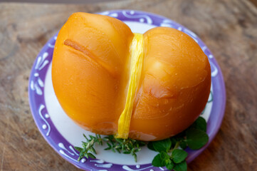 Italian semi hard handmade smoked scamorza cheese, from cow milk from Apulia or Calabria regions close up