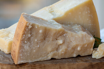 Traditional italian food - 36 months aged in caves Italian parmesan hard cheese from Parmigiano-Reggiano, Italy