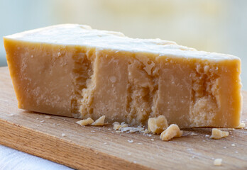 Traditional italian food - 36 months aged in caves Italian parmesan hard cheese from Parmigiano-Reggiano, Italy
