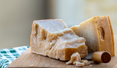 Traditional italian food - 36 months aged in caves Italian parmesan hard cheese from Parmigiano-Reggiano, Italy