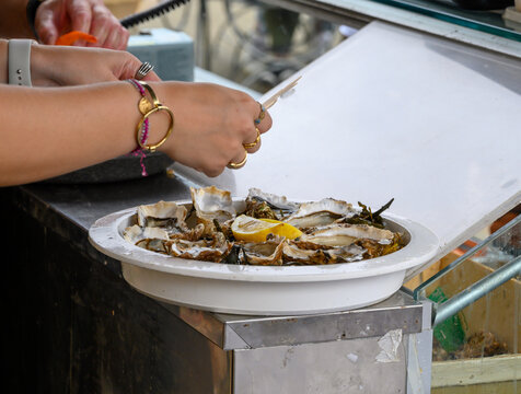 Shucking of Fresh french Gillardeau oysters molluscs on oysters festival in Normandy, france, ready to eat
