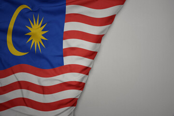Obraz premium big waving national colorful flag of malaysia on the gray background.