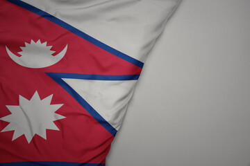 big waving national colorful flag of nepal on the gray background.